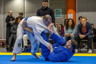 BJJ practioner with opponent in his guard
