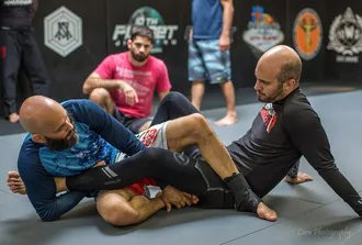 Two BJJ practitioners demonstrating a no-gi technique