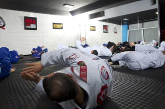 Bjj practitioners shrimping during the warm up